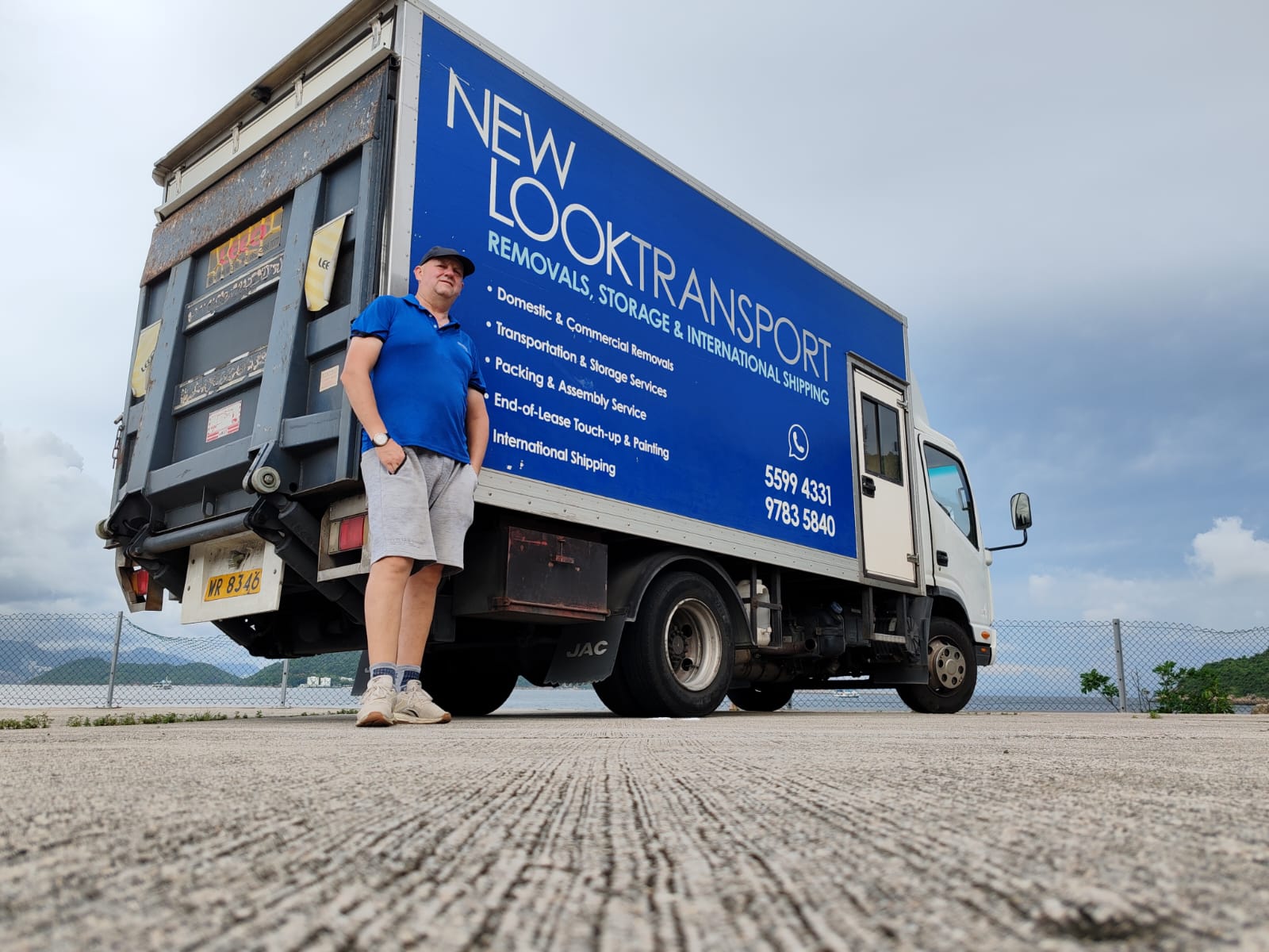 Jason of New Look Transport standing beside the NLT removal truck