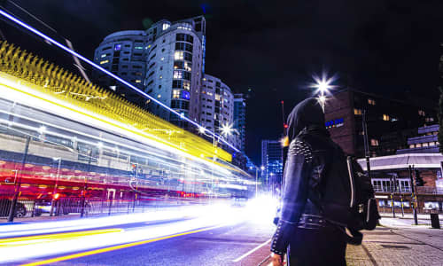 woman standing in a street at night