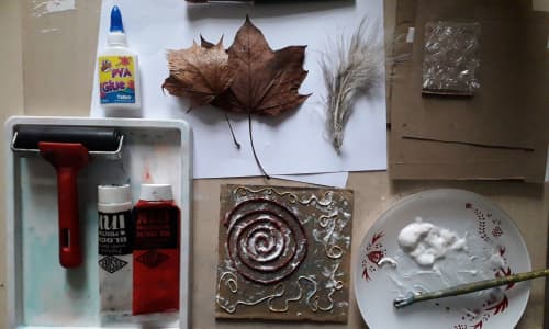 Printing materials, leaves and glue on a table