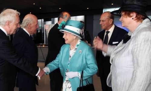 The Queen shaking hands with people