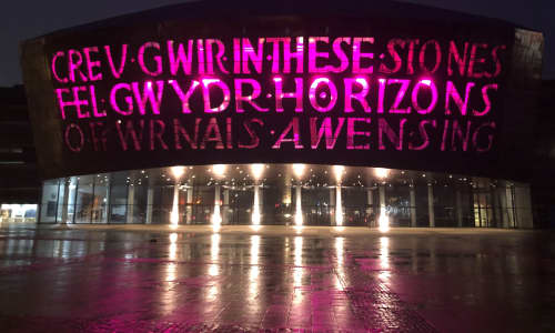 Wales Millennium Centre lit up purple at night