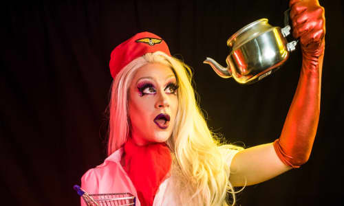 Drag act holding a tea pot