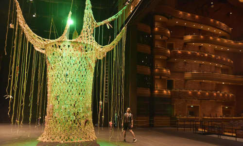 A CROCHET TREE LIT IN GREEN