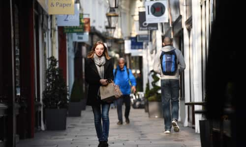 A young woman walking through a Victorian shopping arcade in Cardiff