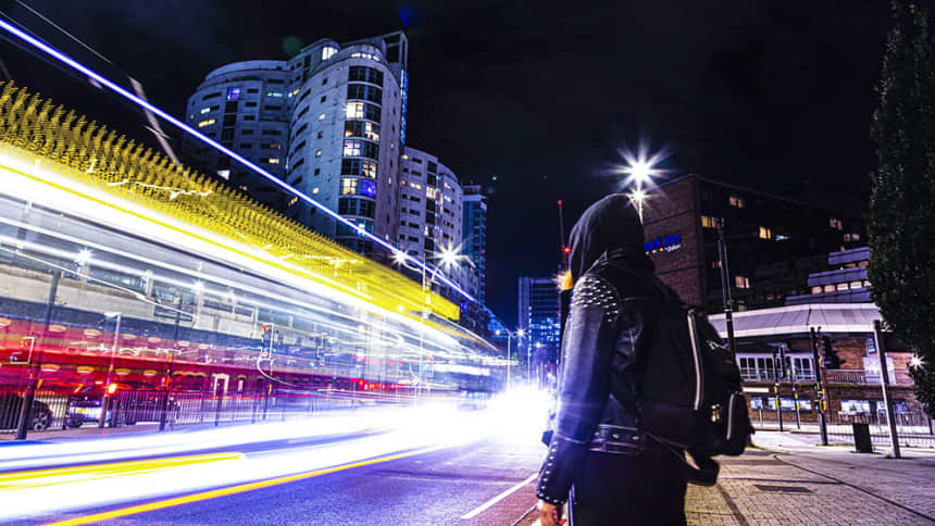 #752 woman stood outside a city at night