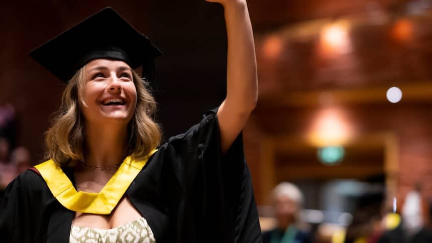 Cardiff Metropolitan University student graduating on the Donald Gordon Theatre stage.