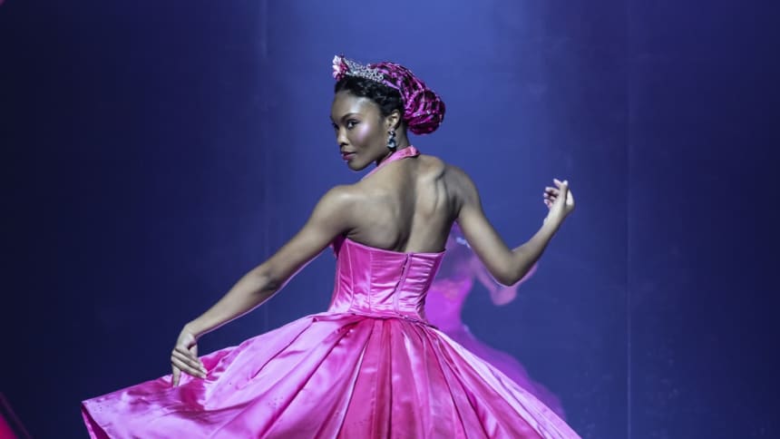 Queen of Sweetieland in pink dress looking back while holding her skirt 