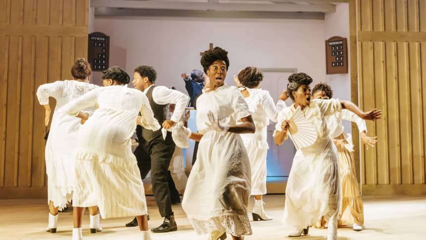 A group of black people dancing and singing in church