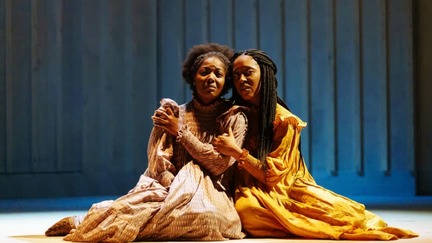 Two women sat on the floor comforting one another 