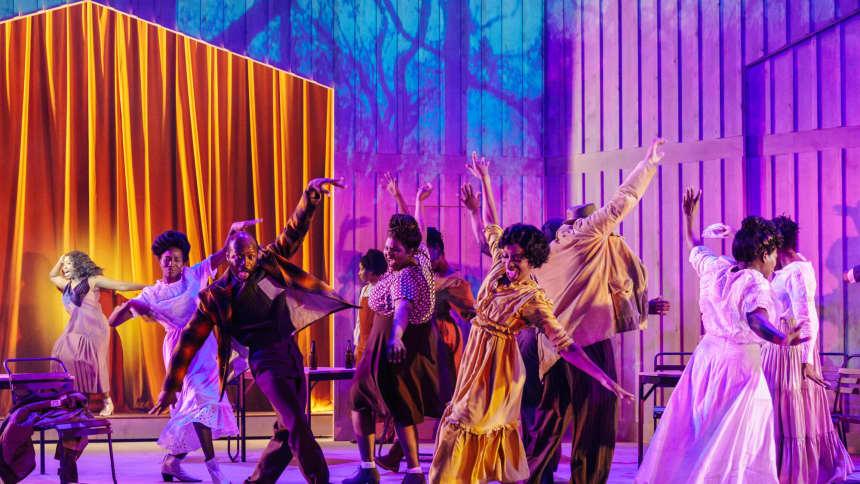 Group of dancers leaning with purple and blue spotlights 