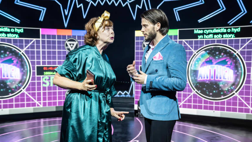 A woman and a man in a TV studio having a confrontation