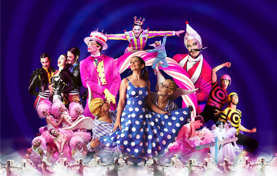 Multiple people in colourful costumes from The Nutcracker dancing and singing
