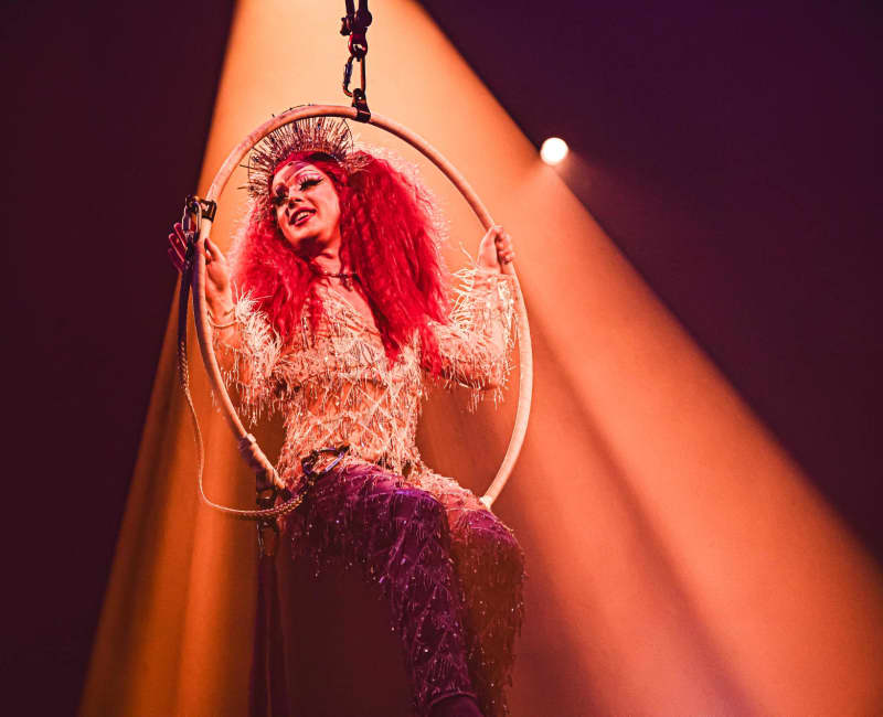 Drag queen Polly Amorous looking absolutely stunning sat in a hoop suspended in the air