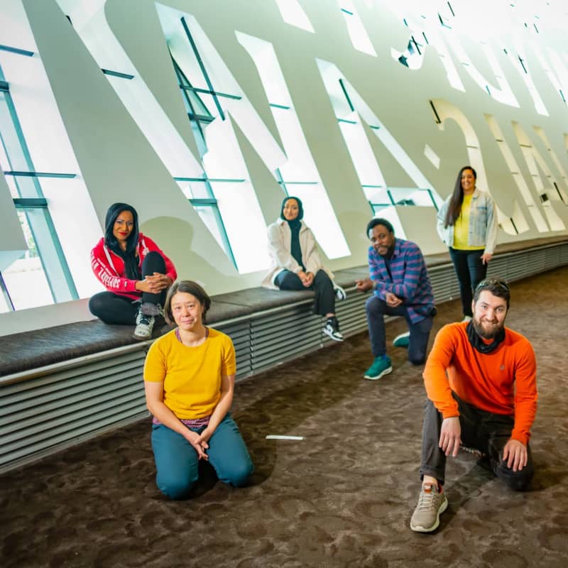 Group shot of our Creative Associates sitting down smiling