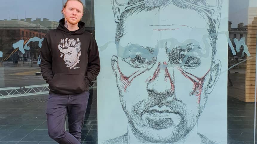 #747 Nathan Wyburn stood next to some art