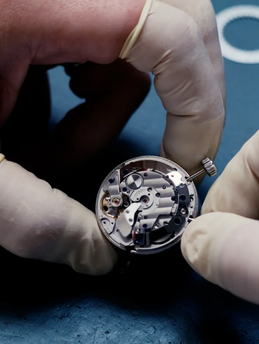 An open watch movement under inspection