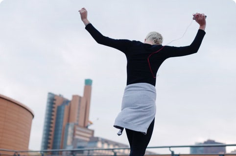 A lady with grey hair celebrating her success after a run.