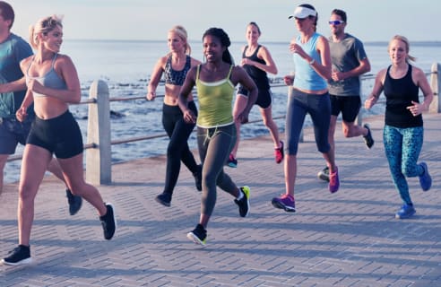 How To Play - Group of people running near the water