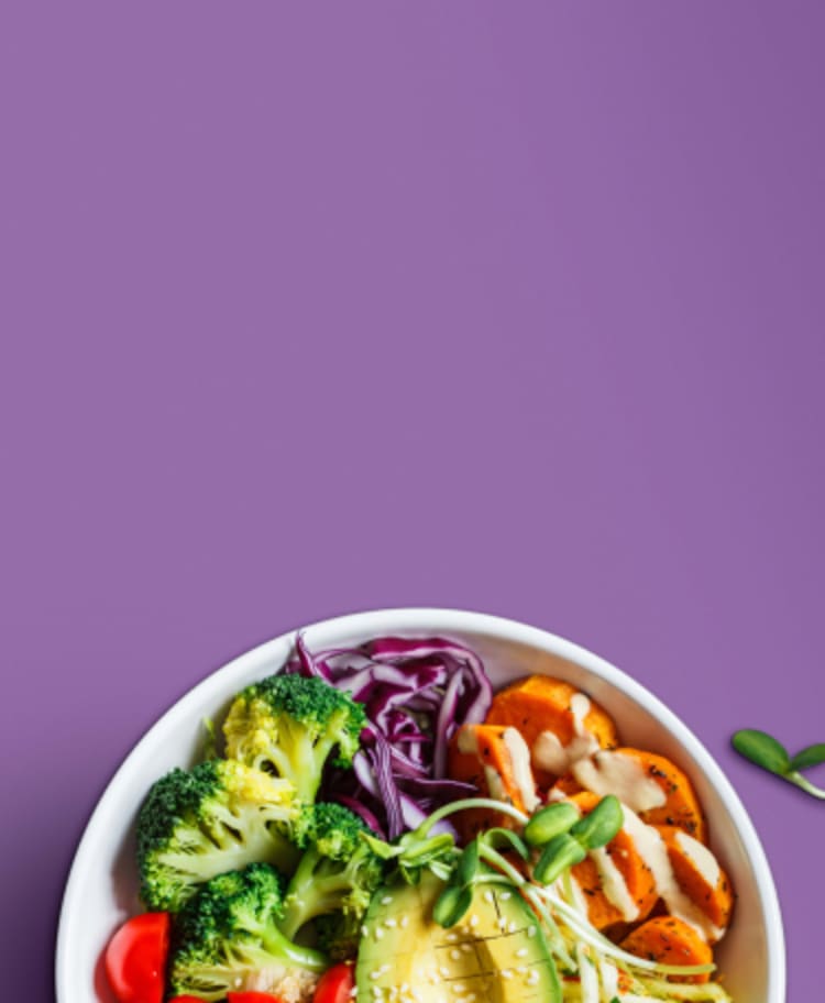 bowl of health plant-based food on a purple background