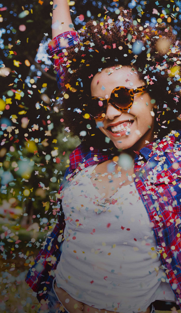 Happy women throwing up confetti