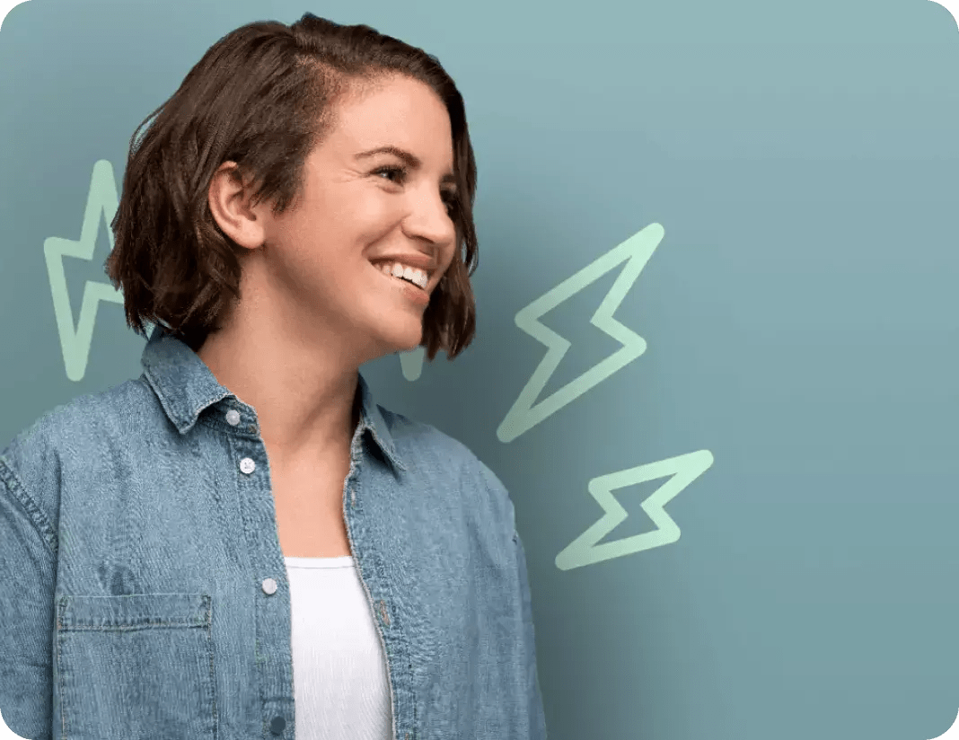 Smiling woman in front of mint colored wall featuring lightning bolt graphics