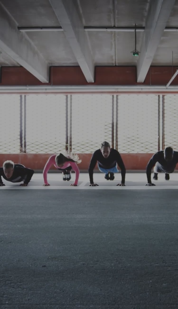 Image of several people doing push-ups.