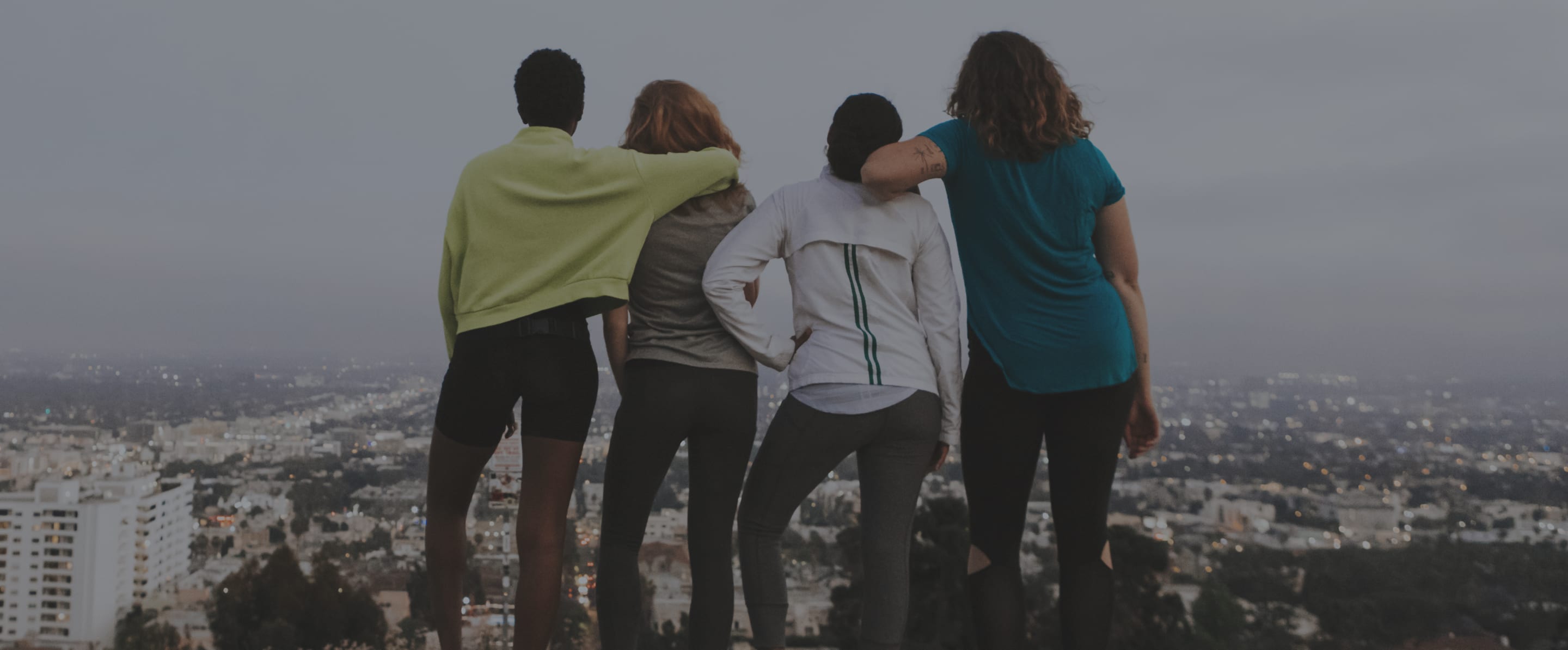 Friends looking at skyline of city together