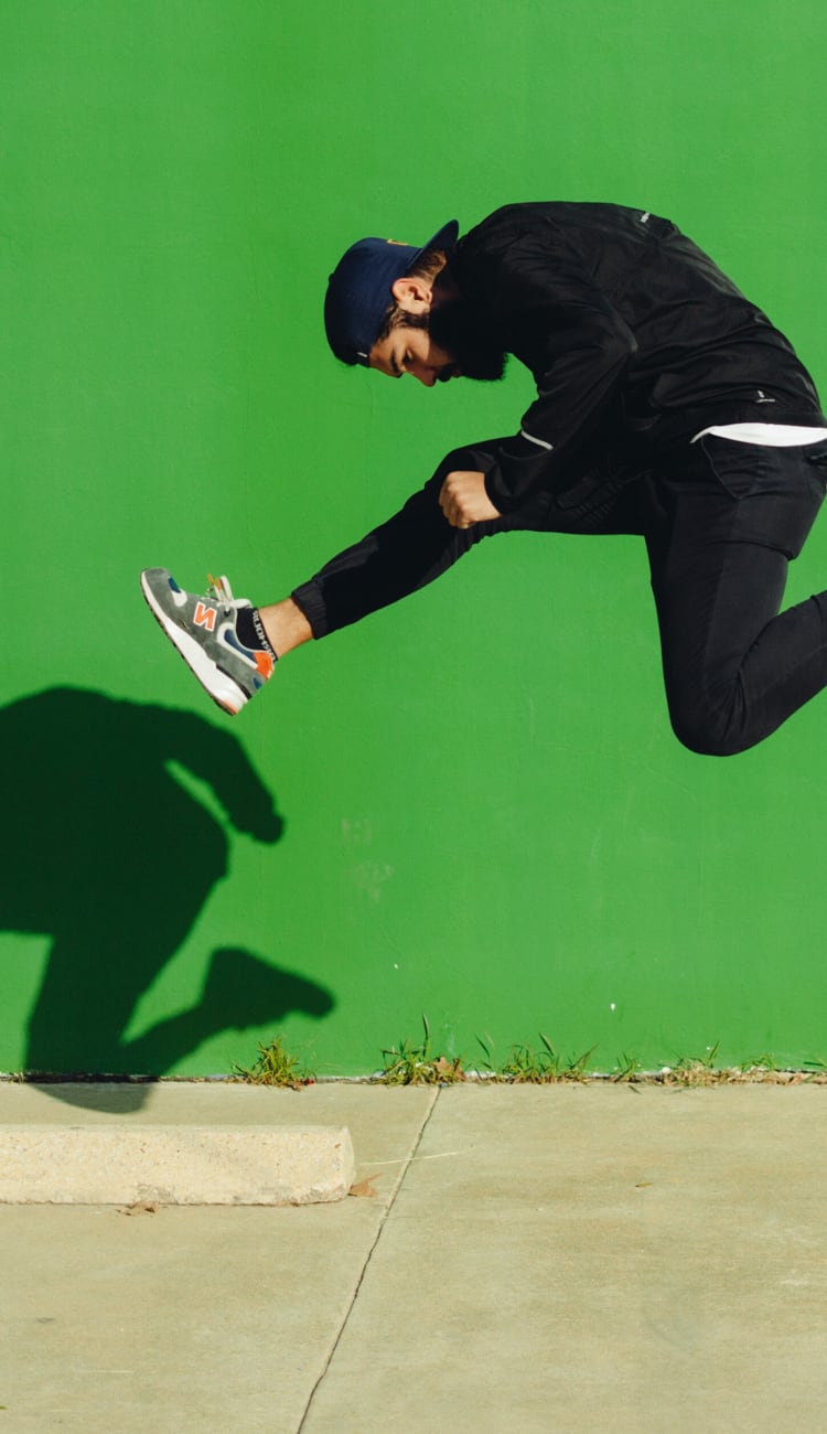 Image of male hurdling on the sidewalk