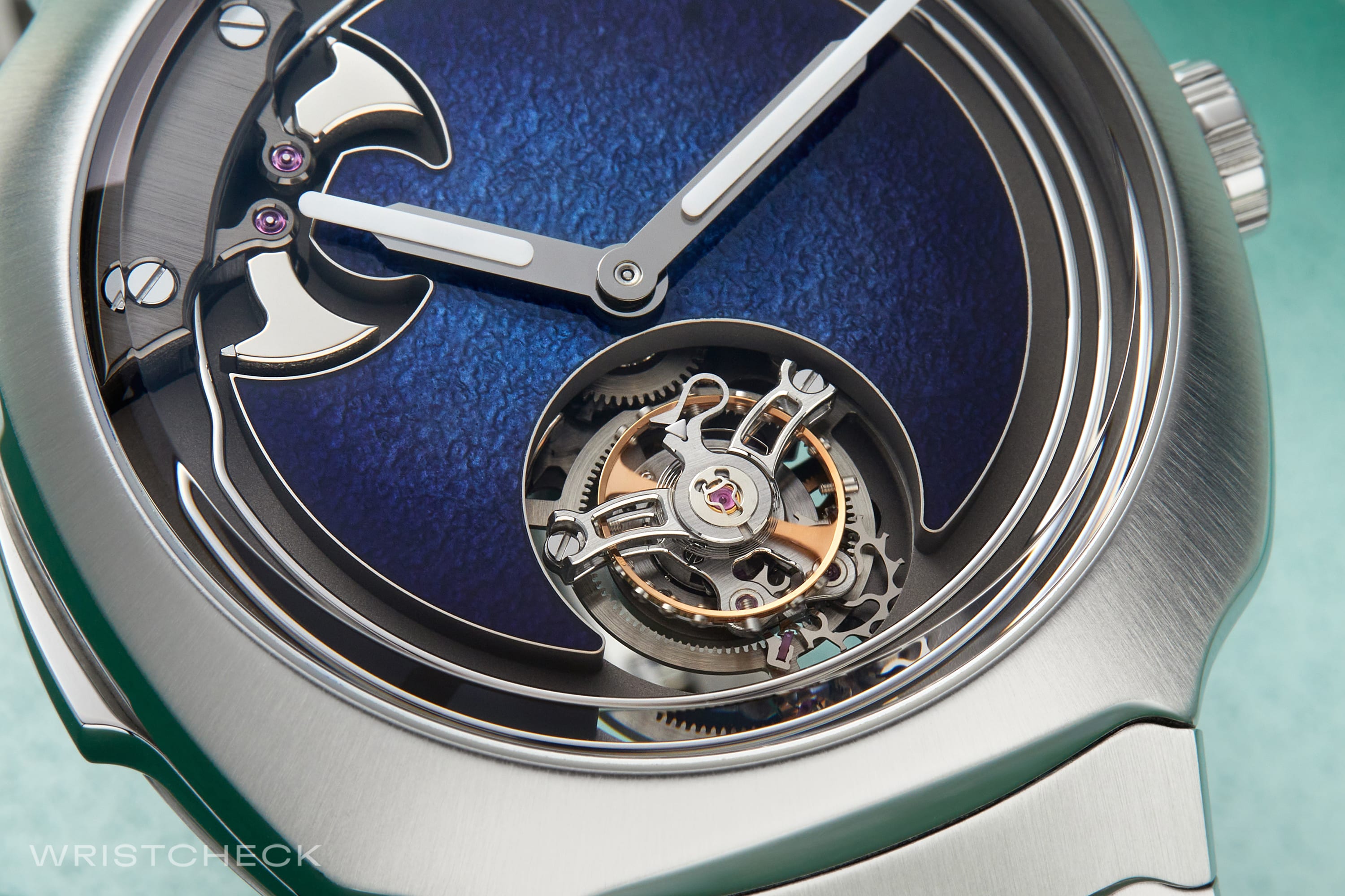 The unique texture and luminosity of the dial is achieved by layering hammered gold with layers of blue pigment