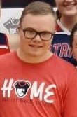 profile closeup of tristan wearing glasses and a red tshirt