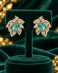 Elegant aqua blue gemstone stud earrings with oval center and CZ halo