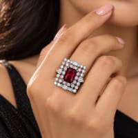 Silver-tone statement ring with large ruby-red rectangular center stone and clear CZ accents
