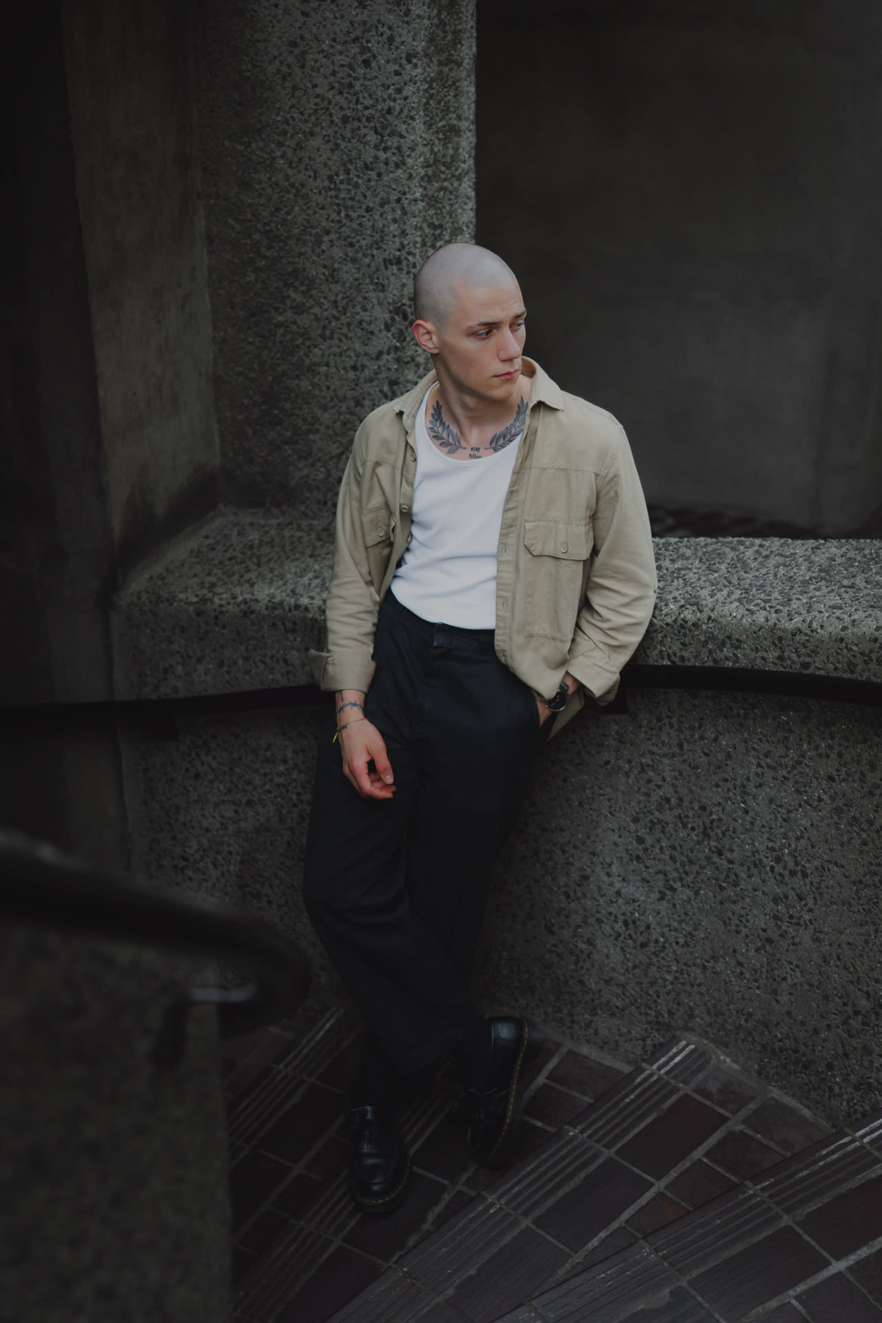 Portrait of a guy standing on concrete stairs