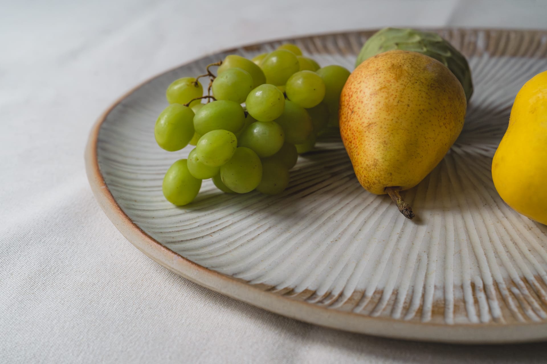 Large ceramic plate with colourful tropical fruit on top