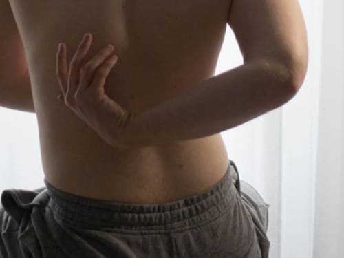 Morning back pain and stiffness being assessed by an osteopath in Ealing