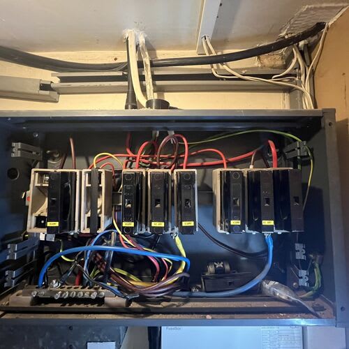 Chase Farm Electrical Contractors conducting an EICR on an old fuse board in a nursing home for safety and compliance