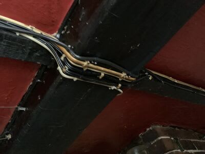 Existing cable routes around the pub’s beams before the rewire.