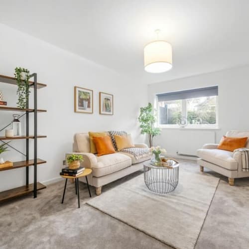 Living room styled with hints of burnt  orange and yellow  to give a modern contemporary look, 4 bedroom property in Beckenham     
