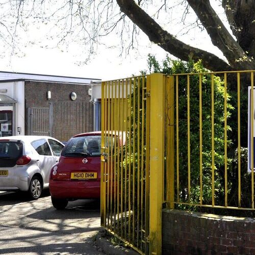 Commercial electrician fitting new lighting and power sockets in a classroom