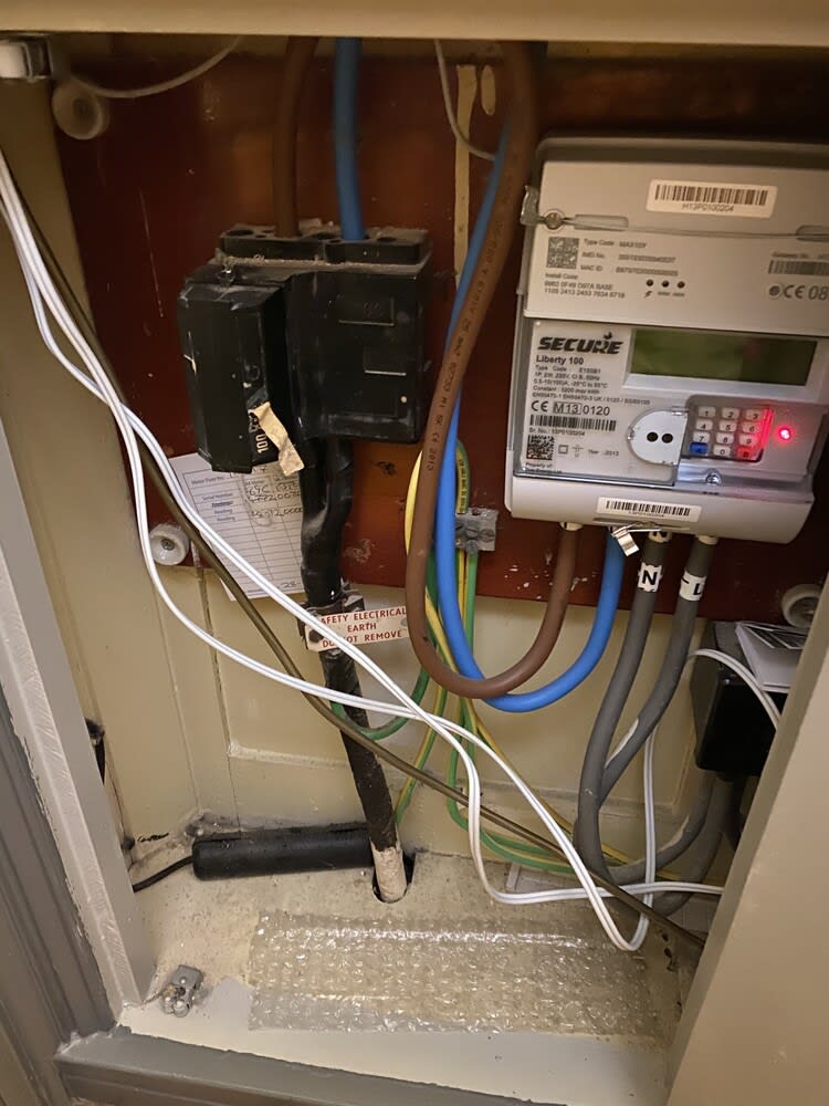 Electrician conducting an Electrical Installation Condition Report (EICR) in a residential property.