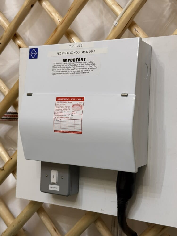 Certified electrician from Chase Farm Electrical working on a fuse box in a modern Southampton business