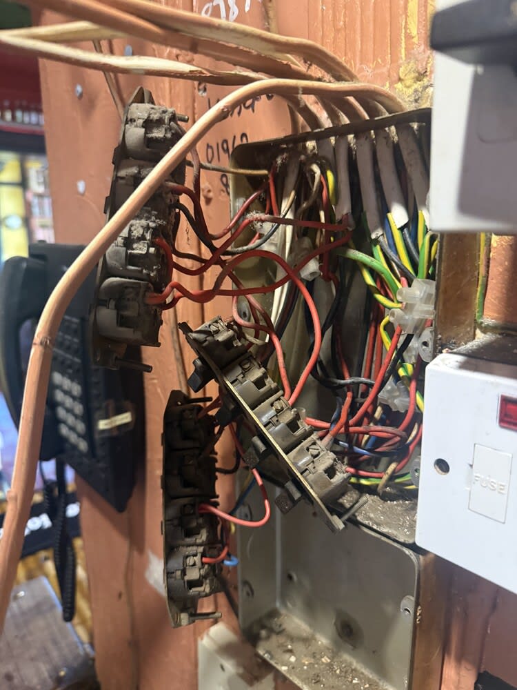 Rear wiring and connections behind switches at the Winchester pub before its rewire