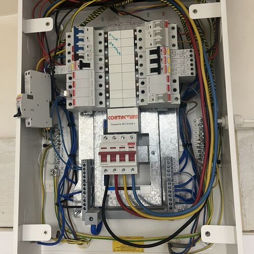 Chase Farm Electrical Contractors conducting an Electrical Installation Condition Report on an old 3 phase fuse board in a nursing home for safety and compliance
