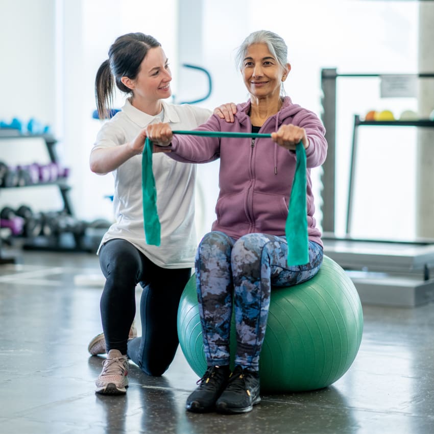 Female physiotherapist working with elderly patient