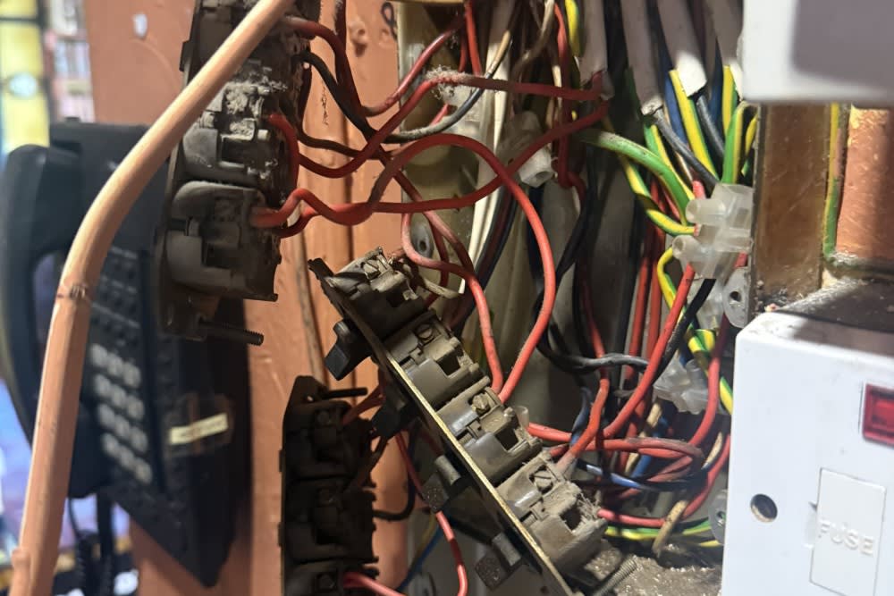 Rear wiring and connections behind switches at the Winchester pub before its rewire