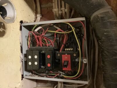 Older distribution board and wiring at a Winchester pub before rewiring