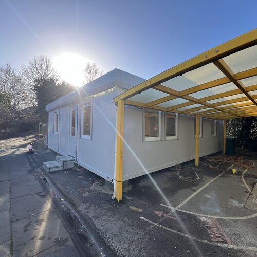 Commercial electrician testing electrical safety in a classroom