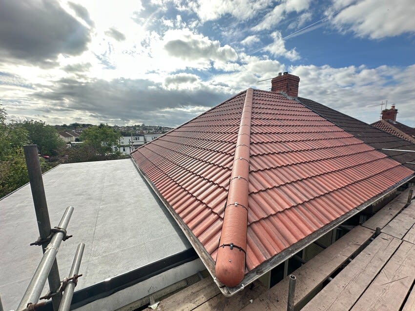 Completed red tiled roof replacement and adjoining new EPDM flat roof by Alpine Home Maintenance Ltd in Southmead, Bristol