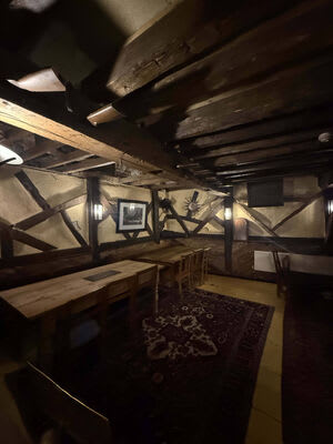 Lighting within one of the pub’s timber-framed dining areas.