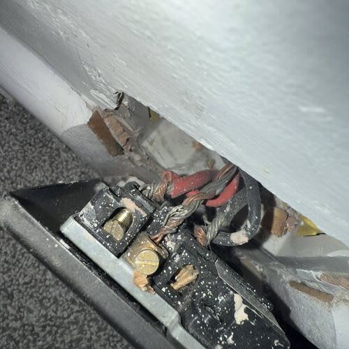 Landlord discussing EICR report findings with letting agent at a property